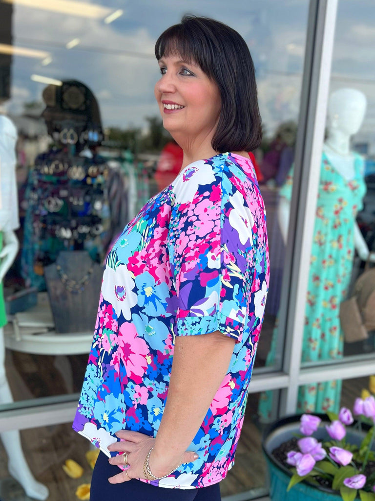 Floral Center Seam V-Neck Blouse (Online Only) - Made by Trendsi , available in , located in Panama City, FL.